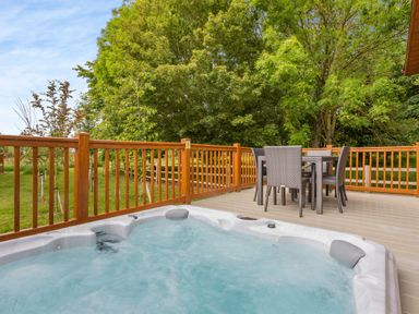 An outdoor area with a hot tub and seating at The Nassington (Pet) in Kings Cliffe