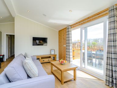 A living room with a sofa and television at The Yarwell in Kings Cliffe