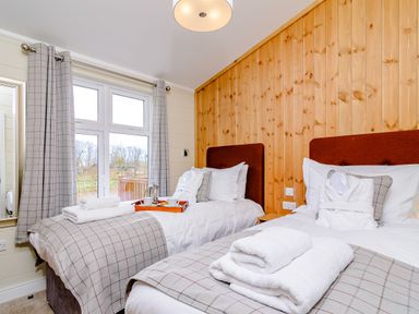 A bedroom with two beds and a window at The Yarwell in Kings Cliffe