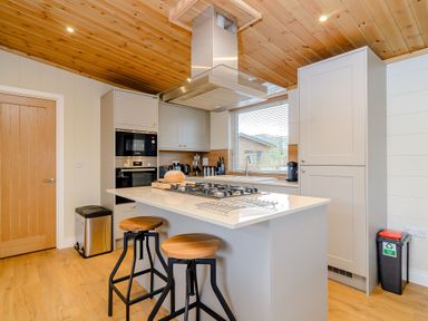 A kitchen with an island and gas stove at The Wansford in Kings Cliffe