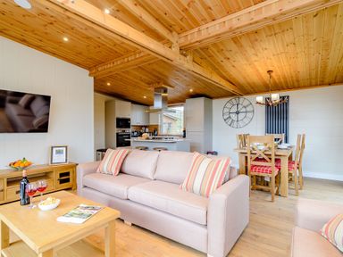 A living room with a sofa and dining area at The Wansford in Kings Cliffe