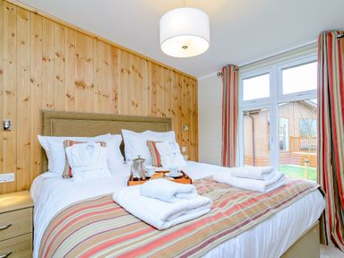 A bedroom with a bed and window at The Wansford in Kings Cliffe