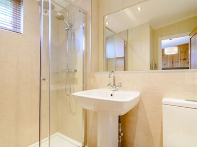 A bathroom with a shower, sink, and toilet at The Wansford in Kings Cliffe