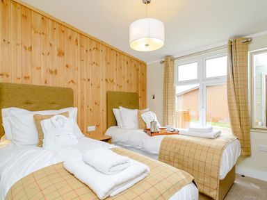A bedroom with two beds and a window at The Wansford in Kings Cliffe