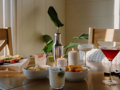 A dining table with cocktail glasses and fruit bowls at The Wansford in Kings Cliffe