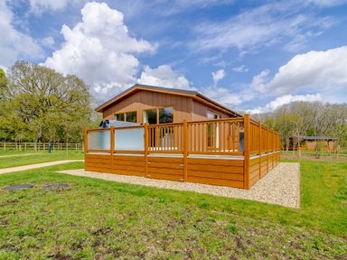 A house with a wooden deck and grass area at The Yarwell (Pet) in Kings Cliffe