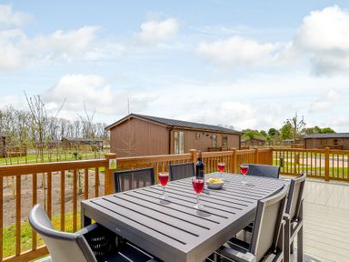 A patio area with a table and chairs at The Yarwell (Pet) in Kings Cliffe