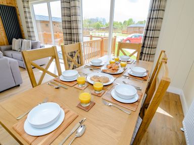 A dining room with a table set for breakfast at The Yarwell (Pet) in Kings Cliffe