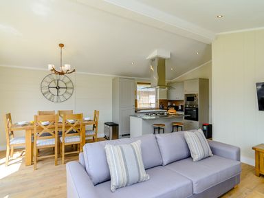 An open plan living area with a sofa and dining table at The Yarwell (Pet) in Kings Cliffe