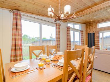A dining room with a table set for breakfast at The Wansford (Pet) in Kings Cliffe