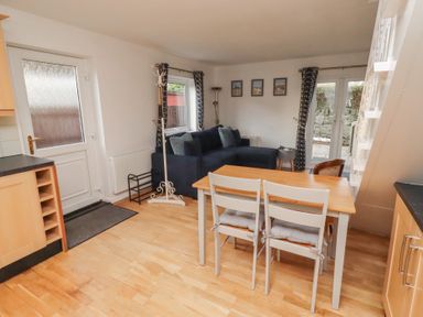 A dining room with a table and chairs at Beadlin cottage Beadnell