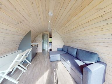 A living room with a sofa and table at Pod 1 (Pet Friendly) Carnforth