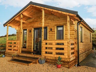 A log cabin with steps and porch at Glenview Log Cabin in Ballycastle