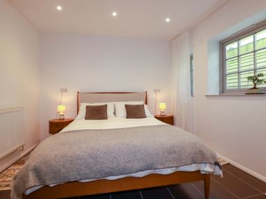 A bedroom with a double bed and bedside tables at The Maisonette in Hayle