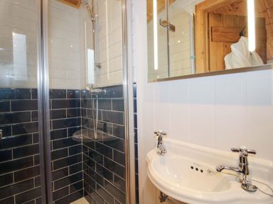 A bathroom with a shower and sink at Dave’s Place Broadstone near Munslow