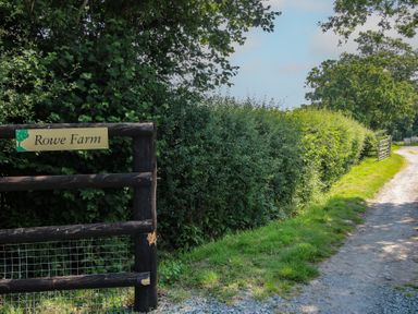 A sign at the entrance of Rowe Farm on a pathway in Munslow