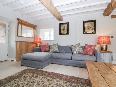 A living room with a sofa and coffee table at Velindra Farm Cottage Hereford