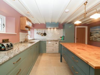 A kitchen with a countertop and kitchen island at Velindra Farm Cottage Hereford
