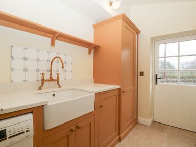 A kitchen with a sink and cabinets at Velindra Farm Cottage Hereford