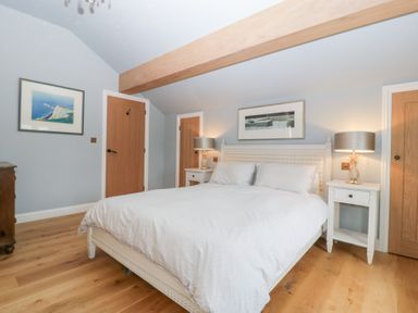 A bedroom with a bed and bedside tables at Velindra Farm Cottage Hereford