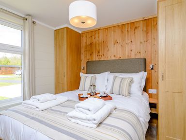 A bedroom with a bed and bedside table at The Alwalton in Kings Cliffe