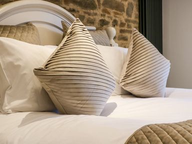 A bedroom with a bed and pillows at Lake View in Crediton