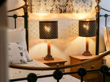 A bedroom with two lamps and wooden nightstands at Lake View in Crediton