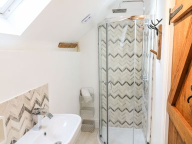 A bathroom with a shower and bathtub at Lake View in Crediton