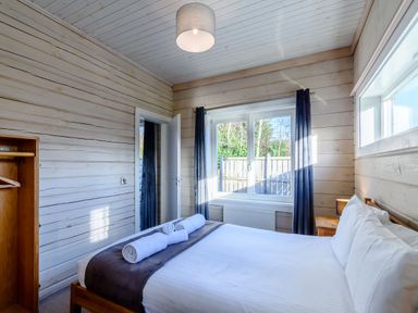 A bedroom with a bed and towels at Chestnut Spa in Carlton Miniott near Thirsk