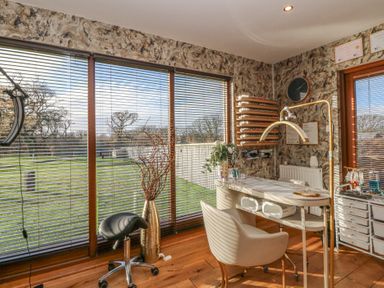 An office with a desk and window overlooking a garden at Garden Lodge 6 Swansea
