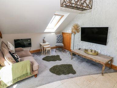A living room with furniture and decor in Rose Apartment, Old Walls, Llanrhidian, Gower