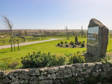 A sign for Gower Retreats with a view of the landscape at Gower Retreats, Old Walls, Llanrhidian, Gower