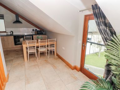 A kitchen with a dining area at Ivy Cottage, Oldwalls, Llanrhidian, Gower
