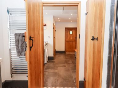 A laundry room with a washing machine and a towel rail at Knowle House in Okehampton