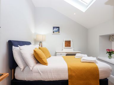 A bedroom with a bed and a dresser at Knowle House in Okehampton