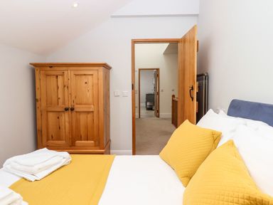 A bedroom with a bed and wardrobe at Knowle House Okehampton