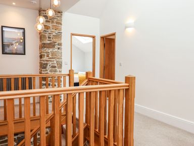 A staircase leading to a hallway at Knowle House in Okehampton