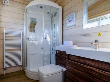 A bathroom with a shower, toilet, and sink at Chestnut Spa (Pet) Carlton Miniott near Thirsk