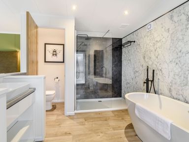 A bathroom with a bath tub and shower at Pear Tree Spa (Pet) Carlton Miniott near Thirsk