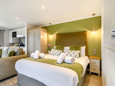 A bedroom with a bed and a couch at Pear Tree Spa (Pet) Carlton Miniott near Thirsk