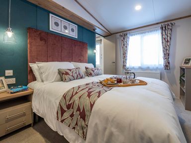 A bedroom with a bed and tray on it at Ellery Waterside Spa Carlton Miniott near Thirsk