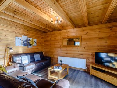 A living room with a sofa and coffee table at Birch Waterside Spa Carlton Miniott near Thirsk