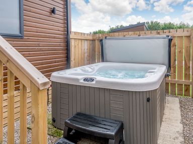 A hot tub in an outdoor area at Cedar Spa Carlton Miniott near Thirsk