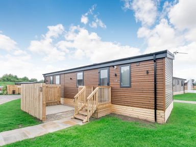 An outdoor view of a property with steps and a fenced area at Cedar Spa in Carlton Miniott near Thirsk