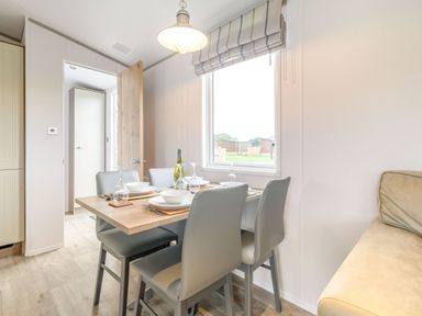 A dining room with a table set for dinner at Cedar Spa in Carlton Miniott near Thirsk