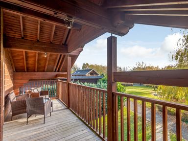 A balcony with chairs and a table at Birch Waterside Spa (Pet) Carlton Miniott near Thirsk