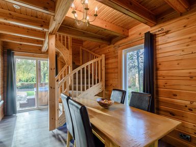 A dining room with a staircase and table at Birch Spa (Pet) Carlton Miniott near Thirsk