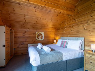 A bedroom with a bed and nightstand at Birch Spa (Pet) Carlton Miniott near Thirsk