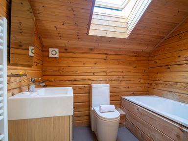 A bathroom with a sink, toilet, and bathtub at Birch Spa (Pet) in Carlton Miniott near Thirsk