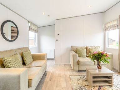 A living room with sofas and a table at Cedar Spa (Pet) Carlton Miniott near Thirsk
